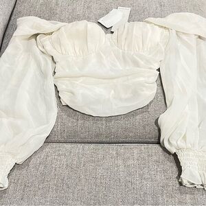 Cream colored, off the shoulder crop top